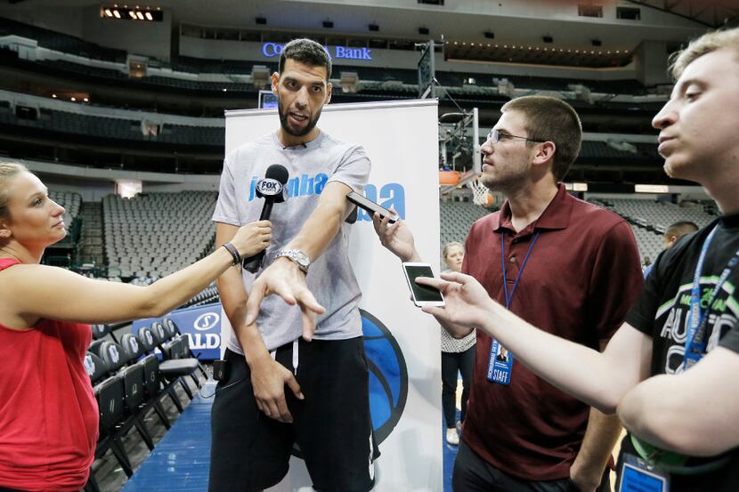 Dallas Mavericks forward Salah Mejri answers questions from the media during a Jr. NBA...