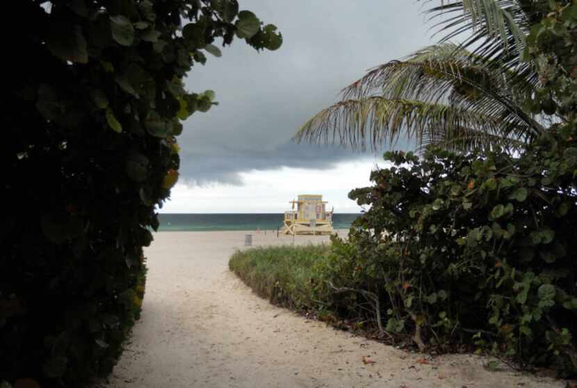 A passing cloudburst creates dramatic skies around a Sunny Isles Beach, Florida, lifeguard...