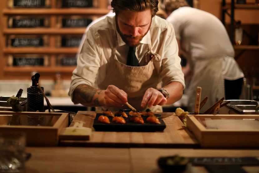 Phillip Frankland Lee prepares a course of raw fish at Sushi By Scratch, a restaurant on the...