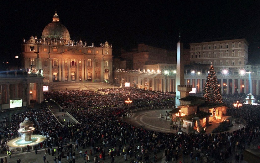 FILE - A view of St. Peter' s Square crowded with faithful watching on giant screens Pope...