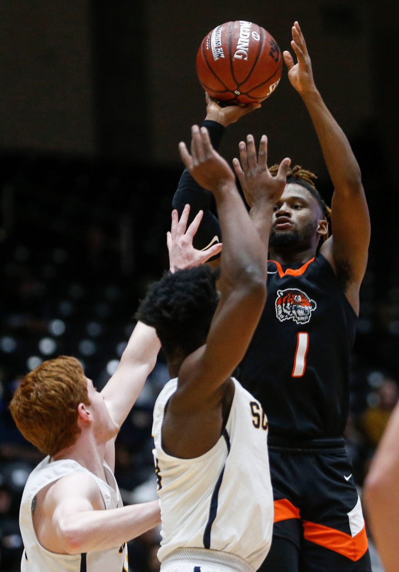 Lancaster's Mike Miles (1) puts up a shot during the first half of a boys basketball UIL...