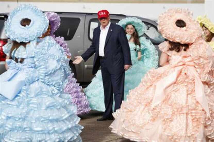 President-elect Donald Trump is greeted by the Azalea Trail Maids after arriving at the...