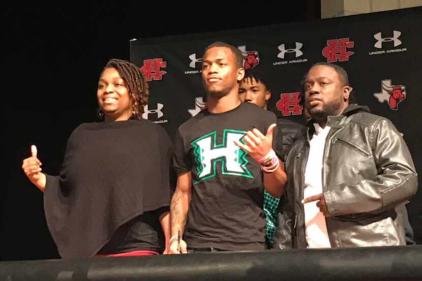 Hawaii signee Quin Bright poses for photographs during Cedar Hill's signing day ceremony on...