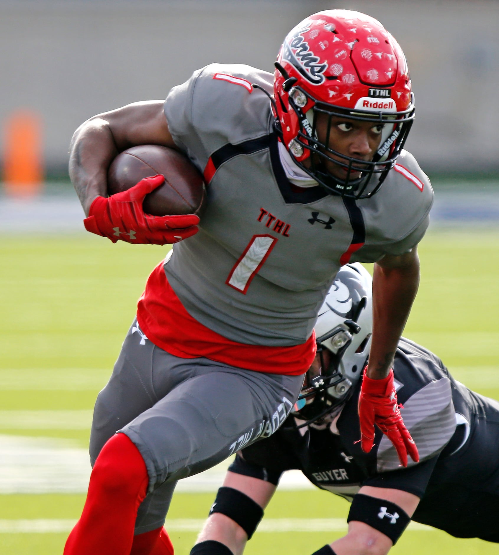 Cedar Hill High School wide receiver Anthony Thomas (1) escapes the tackle attempt by Denton...