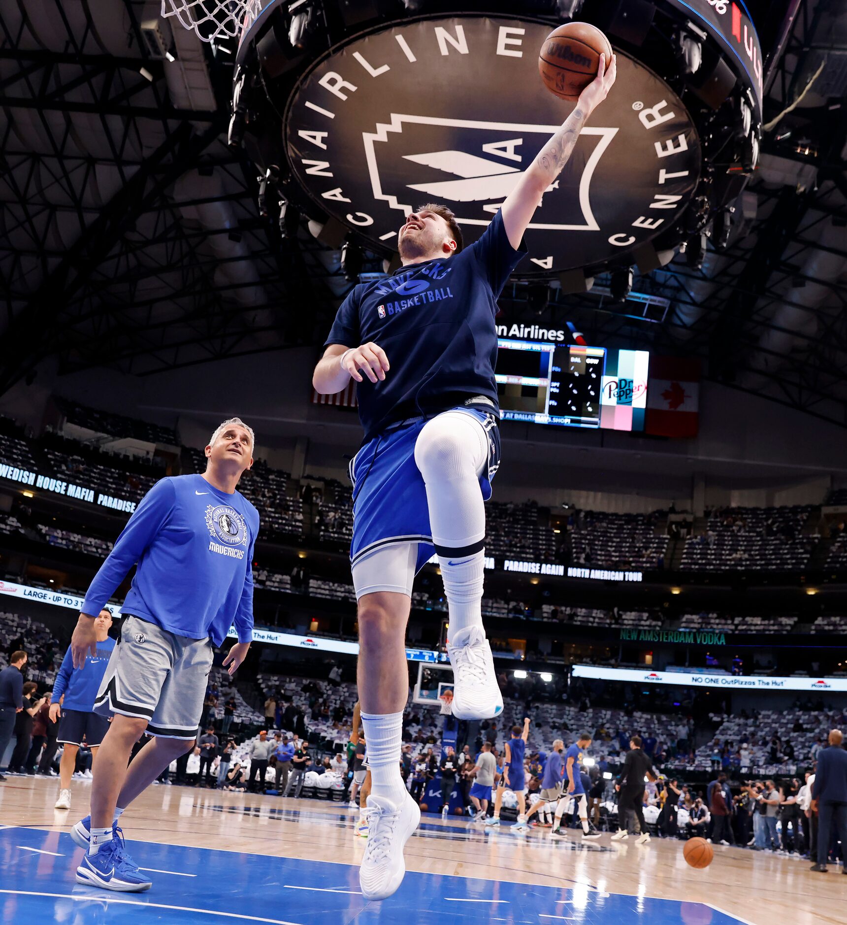 Dallas Mavericks guard Luka Doncic (right) warms up with assistant coach Igor Kokoskov...