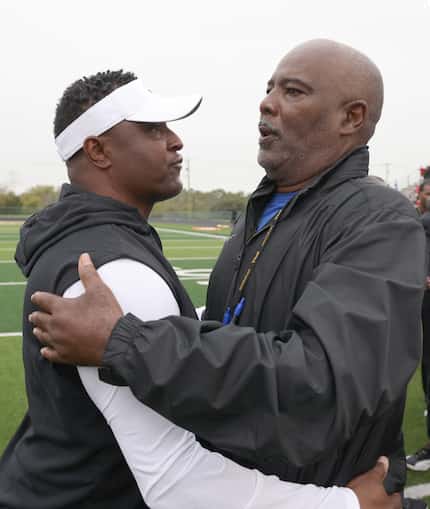 DeSoto Eagles head coach Claude Mathis, left, shares a hug with Duncanville head coach...