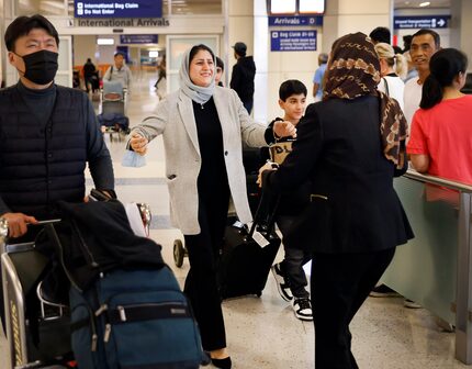 Latifa Sharifi (center, facing), a prominent Afghan women's rights lawyer, is overcome with...