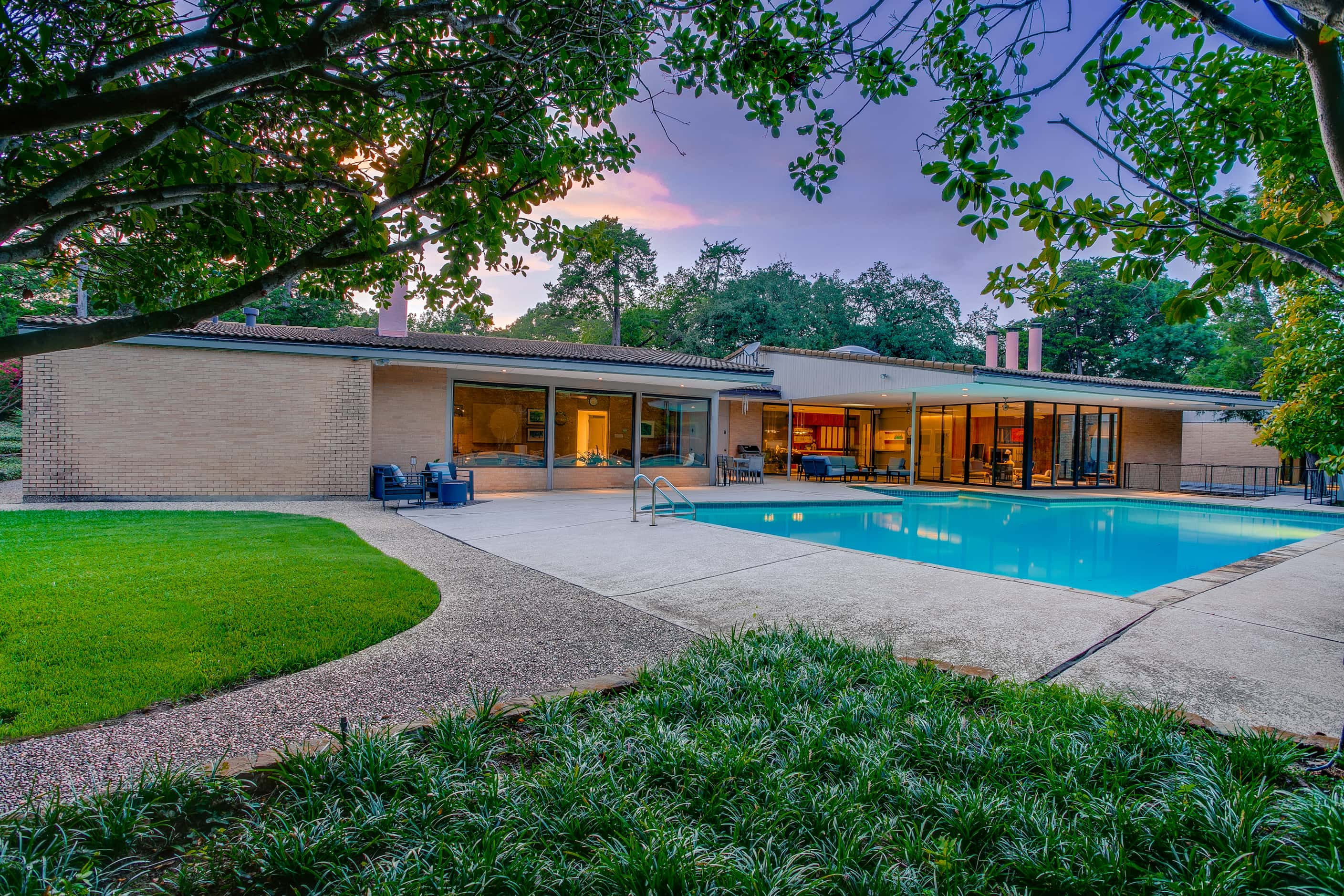 Back view of midcentury modern house with pool and patio