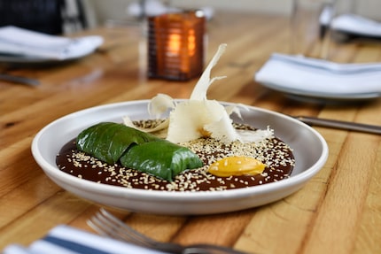 Short rib barbacoa is wrapped in Hoja Santa leaves with mole and sweet potato puree at...