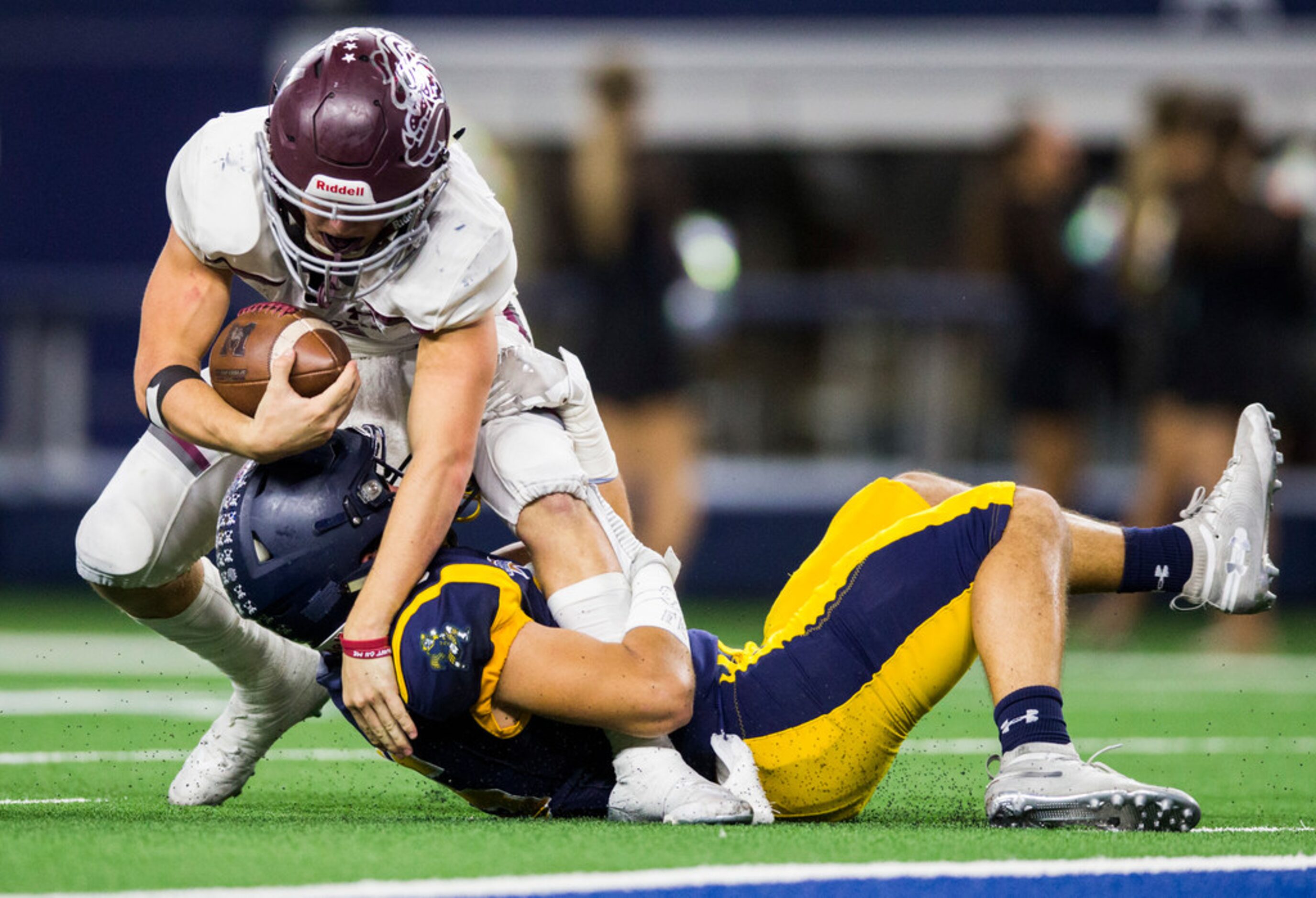 Highland Park defensive back Gus Vincent (15) tackles running back Mitch Hall 5) during the...