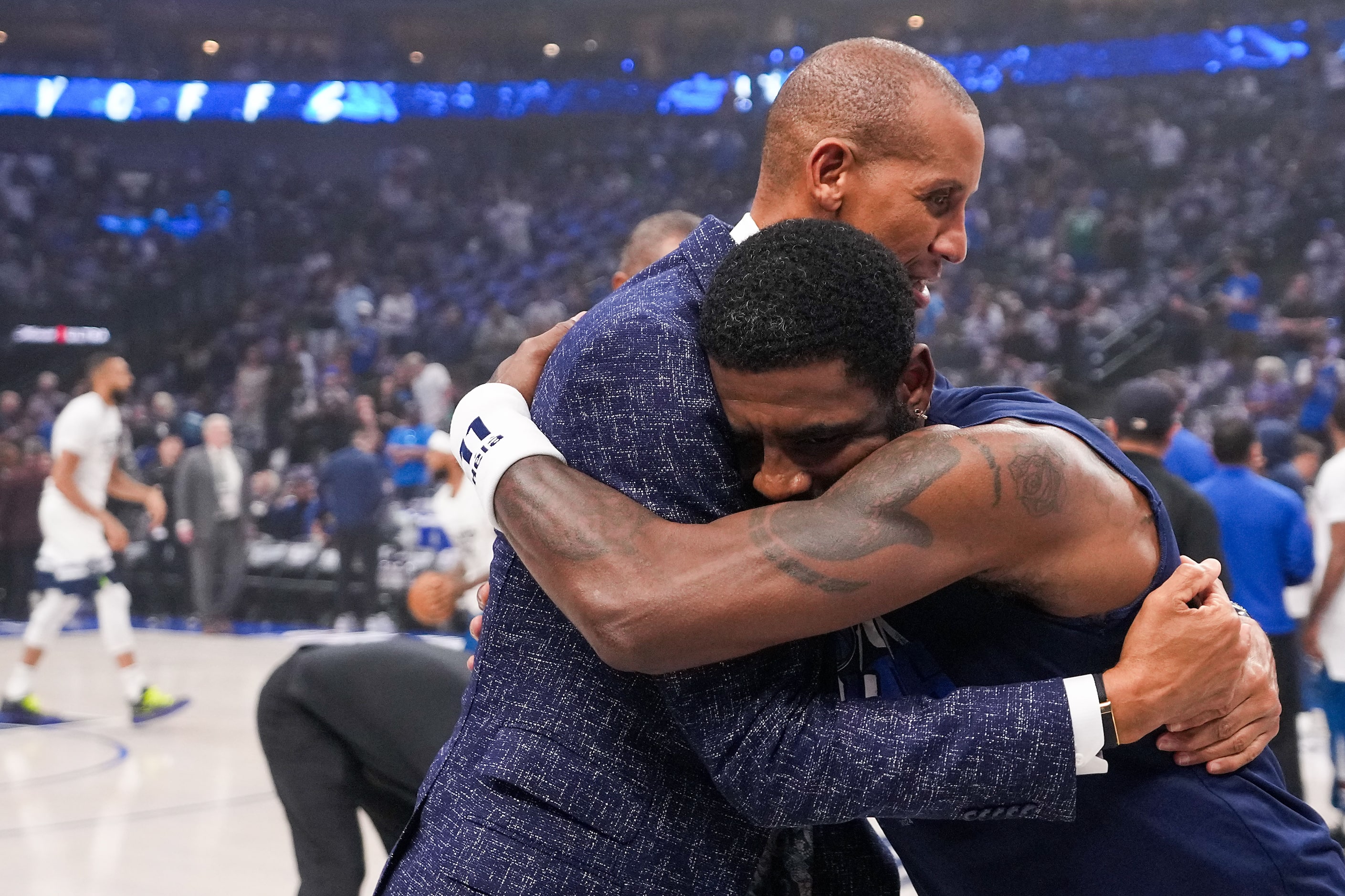 Dallas Mavericks guard Kyrie Irving (right) hugs Reggie Miller before Game 4 of the NBA...