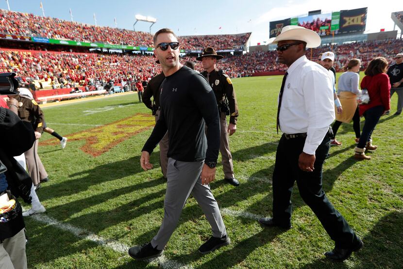 Texas Tech head coach Kliff Kingsbury, center, walks off the field after an NCAA college...