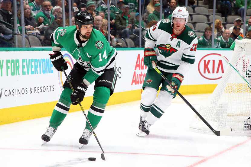 Dallas Stars left wing Jamie Benn (14) is pursued by Minnesota Wild defenseman Ryan Suter...