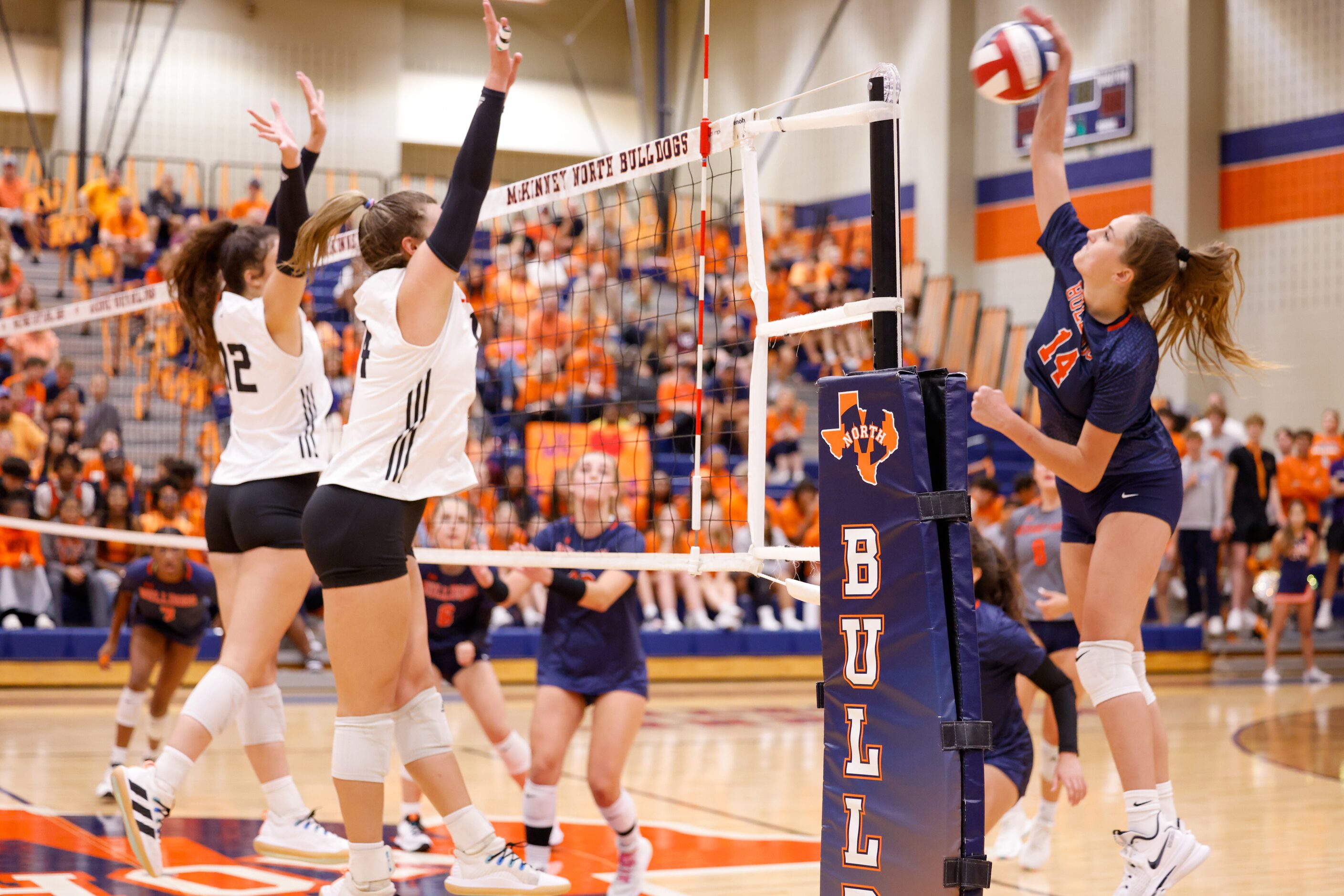 McKinney North Brooke Butler (14) spikes the ball into defending Lovejoy players during the...