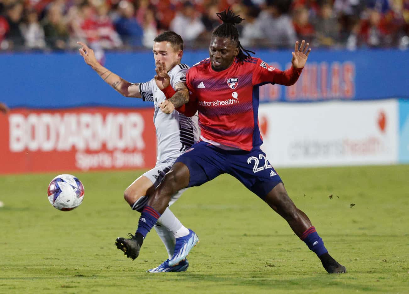 FC Dallas midfielder Ema Twumasi (22) competes with San Jose Earthquakes defender Paul Marie...