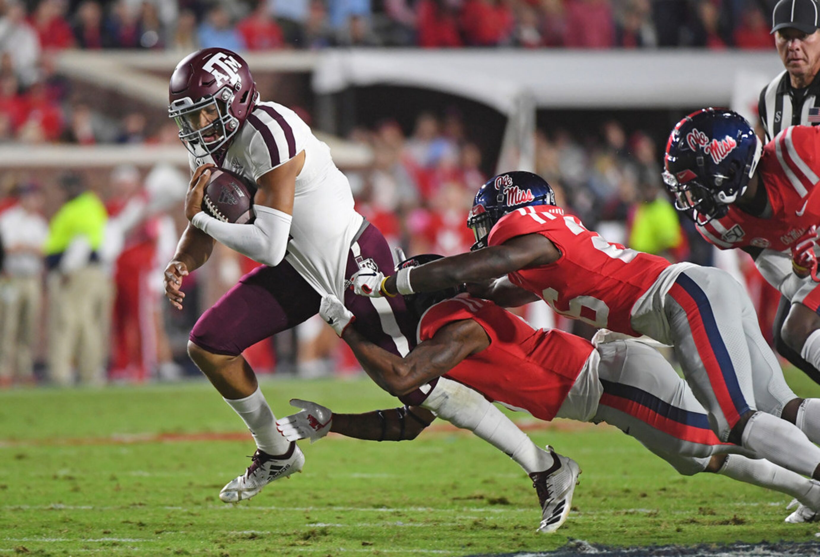 Mississippi defensive backs Jon Haynes (5) and Jalen Julius (26) tackle Texas A&M...