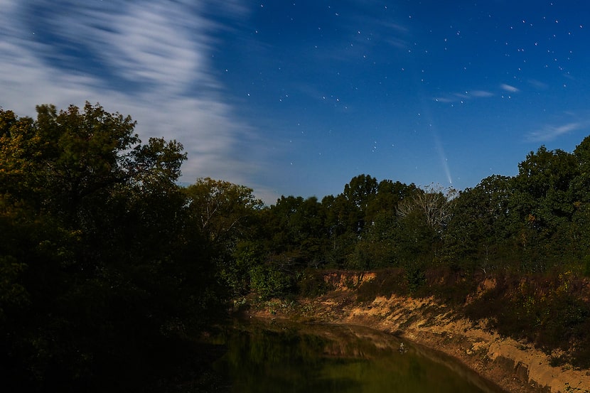 The faint streak of comet Comet A3 Tsuchinshan-ATLAS is seen over the banks of the Sulphur...