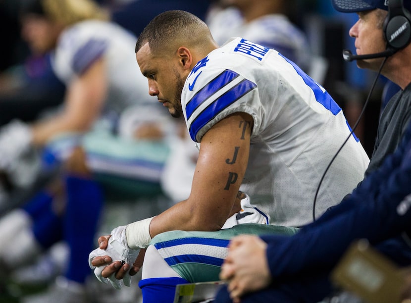 Dallas Cowboys quarterback Dak Prescott (4) sits on the bench during the fourth quarter of a...