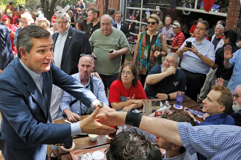 Sen.Ted Cruz works the crowd as he campaigns at the Katy Trail Ice House Outpost in Plano,...