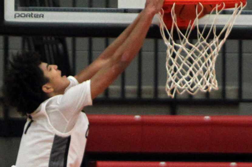 Coppell guard Anthony Black (1) skies to dunk a precisely placed lob pass during second half...