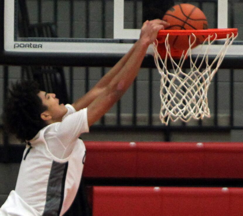 Anthony Black, back when he played for Coppell, skies for a dunk during a game against...