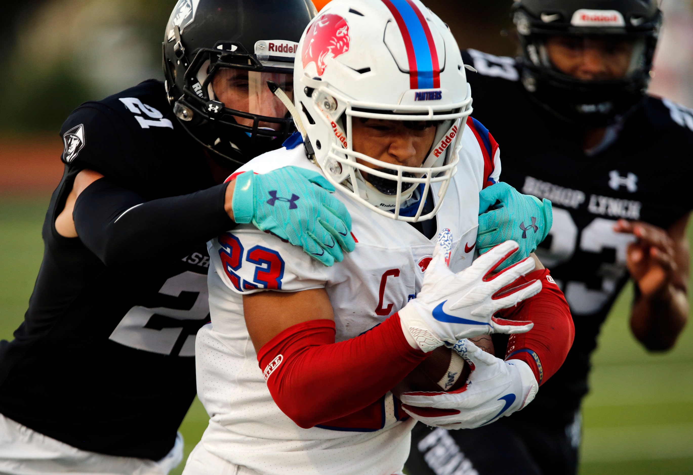 Parish Episcopal’s Christian Benson (23) advances a pass reception, as Bishop Lynch defender...