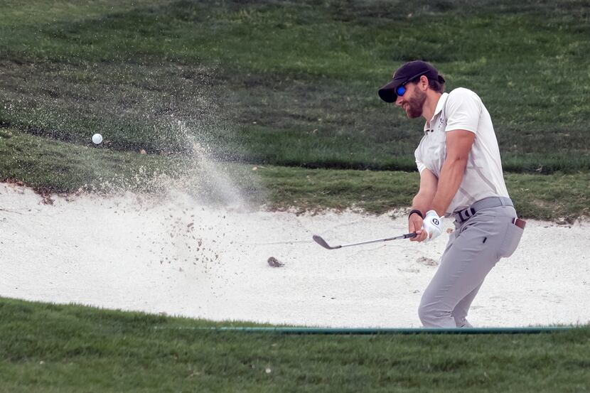 Patrick Rodgers hits out of a bunker on the 18th hole during the third round of the Valero...