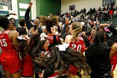 Cheerleaders charge the floor with the bench as Braswell High School defeated Plano East...