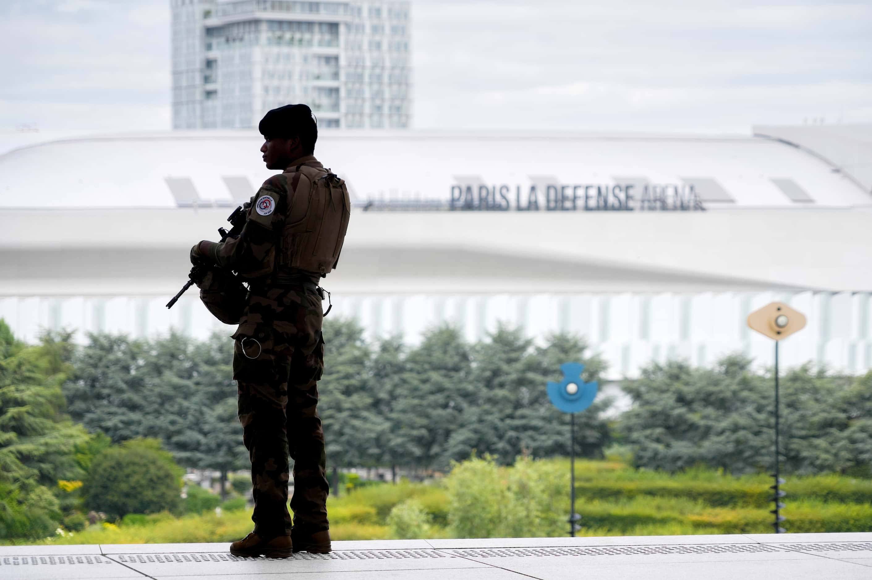 Security forces look out toward París La Défense Arena, the venue for swimming, ahead of the...