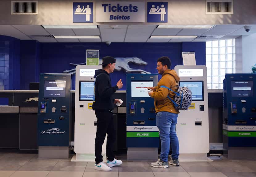 Passengers purchase tickets at the Greyhound bus station on S Lamar St in downtown Dallas,...