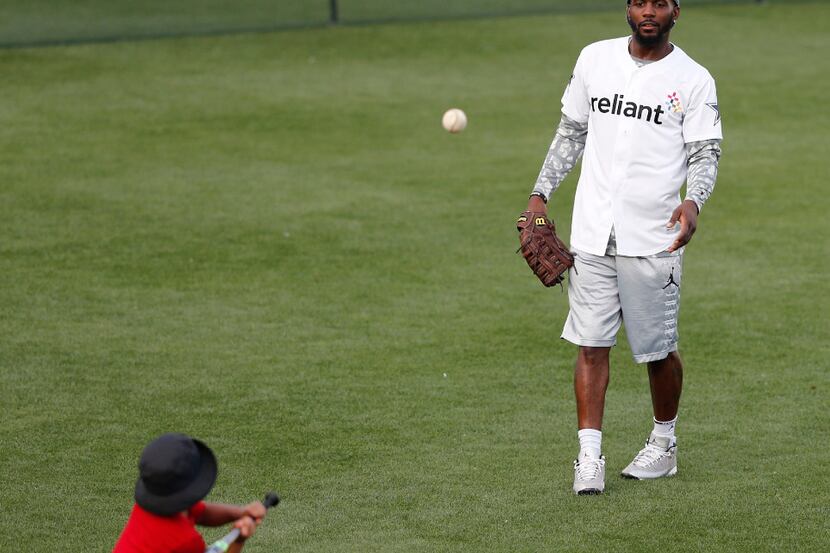 Dallas Cowboys wide receiver Dez Bryant (88) plays baseball with his son after the sixth...