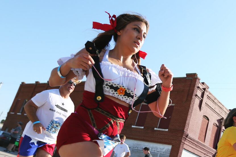 Anna Hernandez, cq, of Mansfield reaches the finish line of the 5K race, as part of the Rahr...