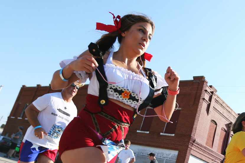 Anna Hernandez, cq, of Mansfield reaches the finish line of the 5K race, as part of the Rahr...