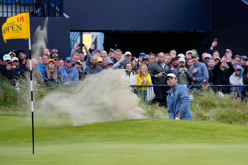 United States' Scottie Scheffler plays out of a bunker on the 18th green during the second...