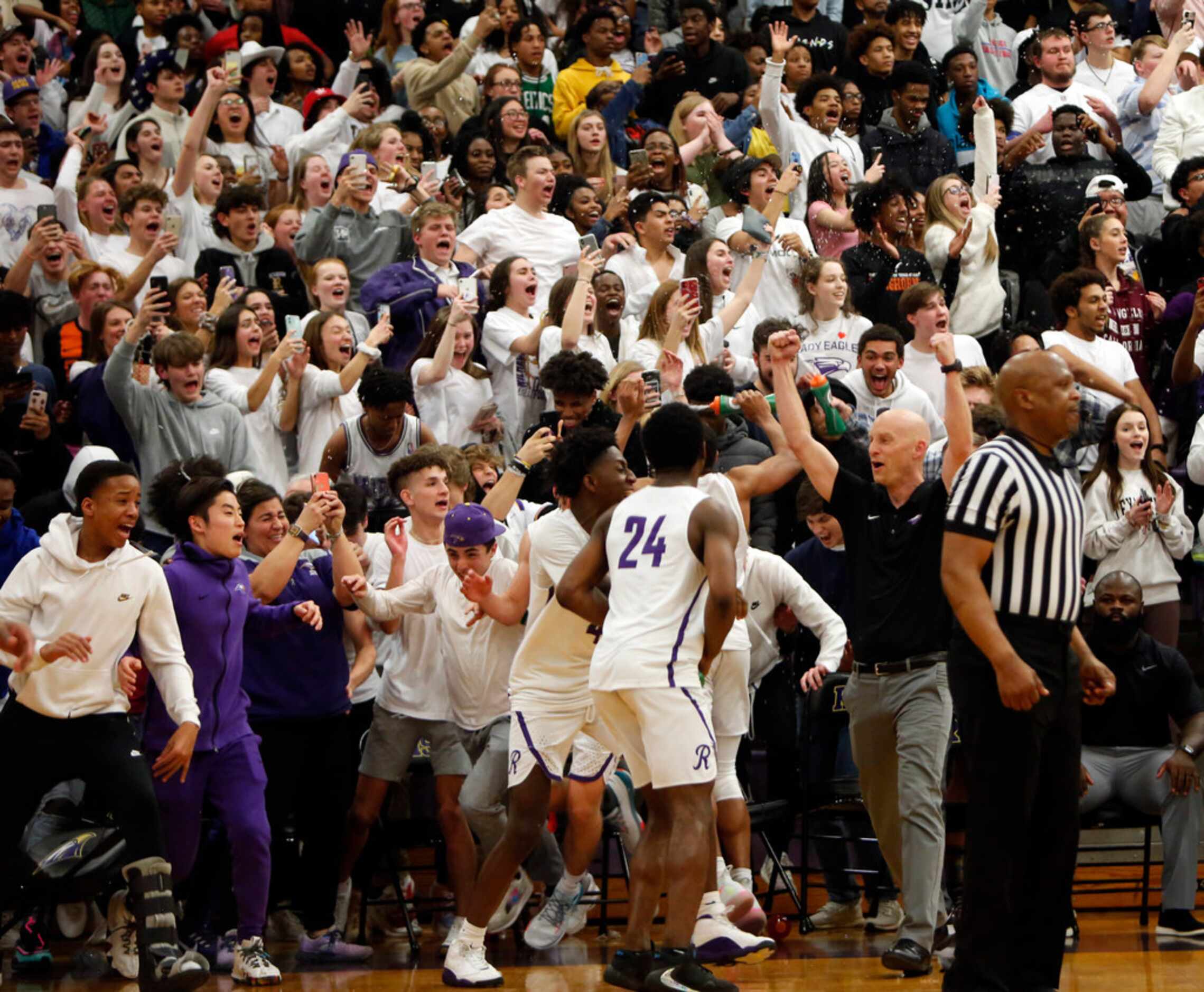Richardson head coach Kevin Lawson lifts his fists in the air as the student section erupts...