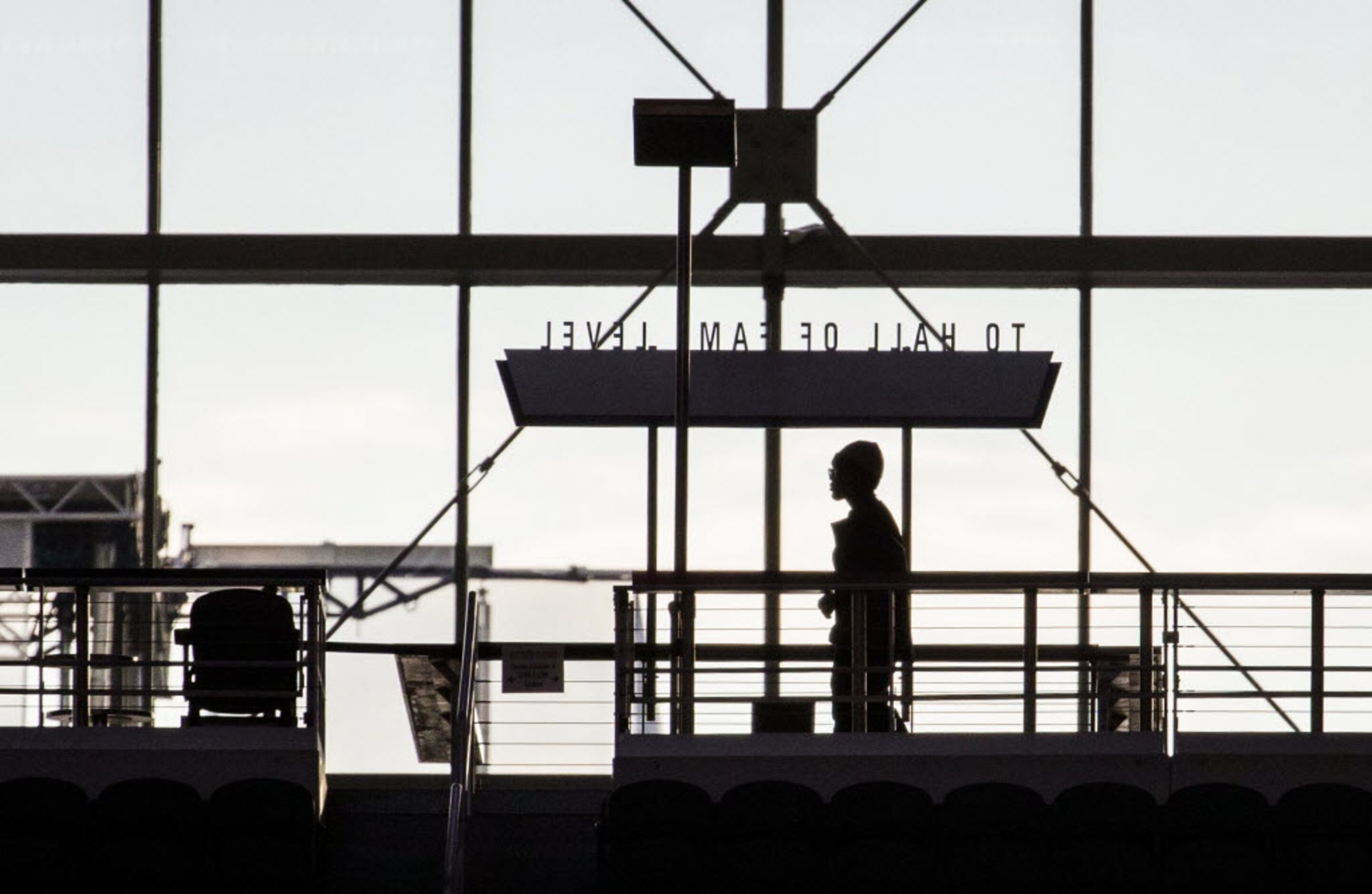 A fan makes her way to her seat on the concourse level of AT&T Stadium while Garland takes...