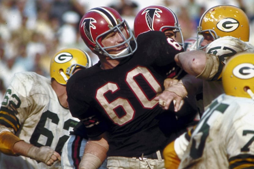 Atlanta Falcons linebacker Tommy Nobis fights off the block of a Green Bay Packers lineman...