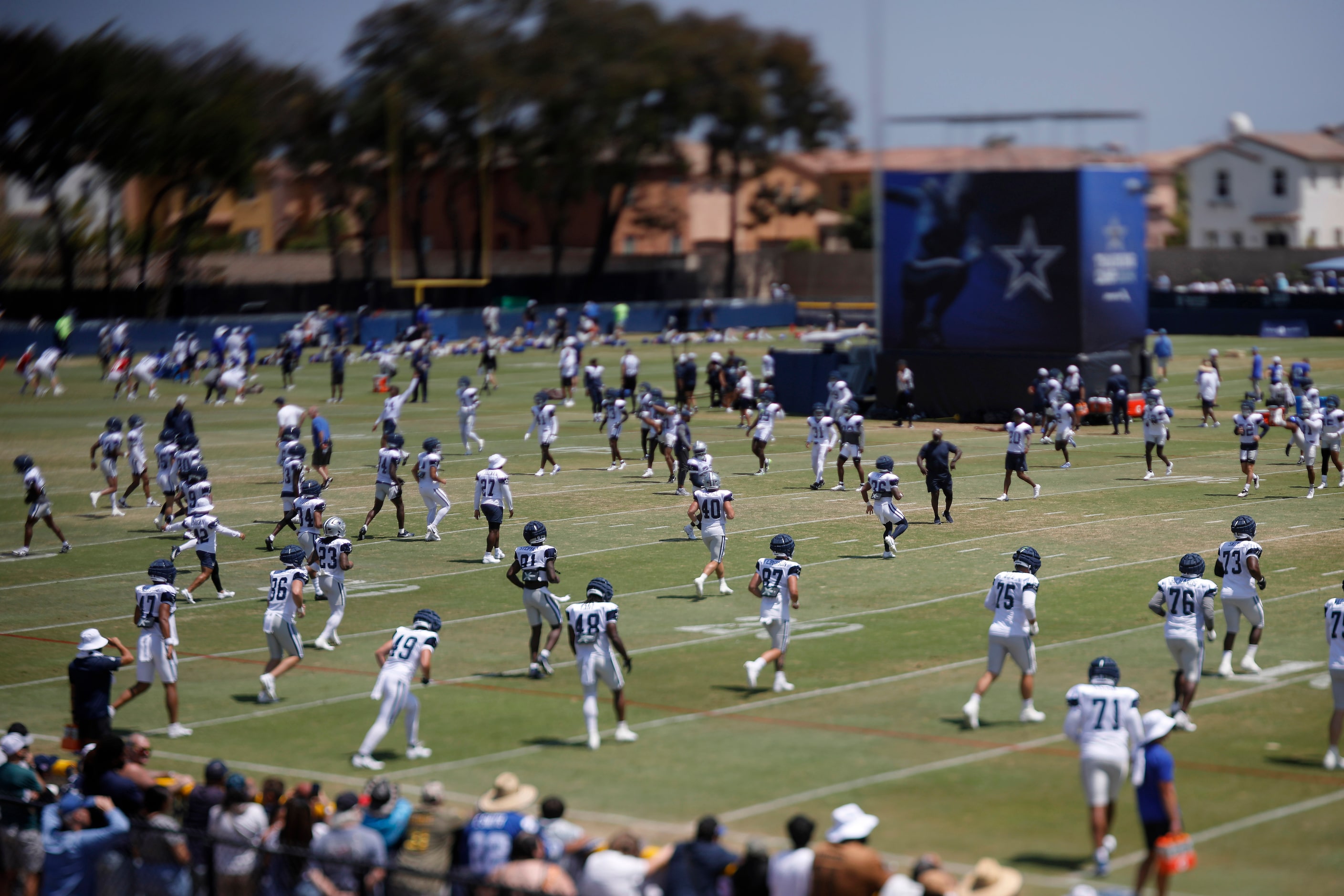 The Dallas Cowboys football team warms up before a scrimmage against the Los Angeles Rams at...