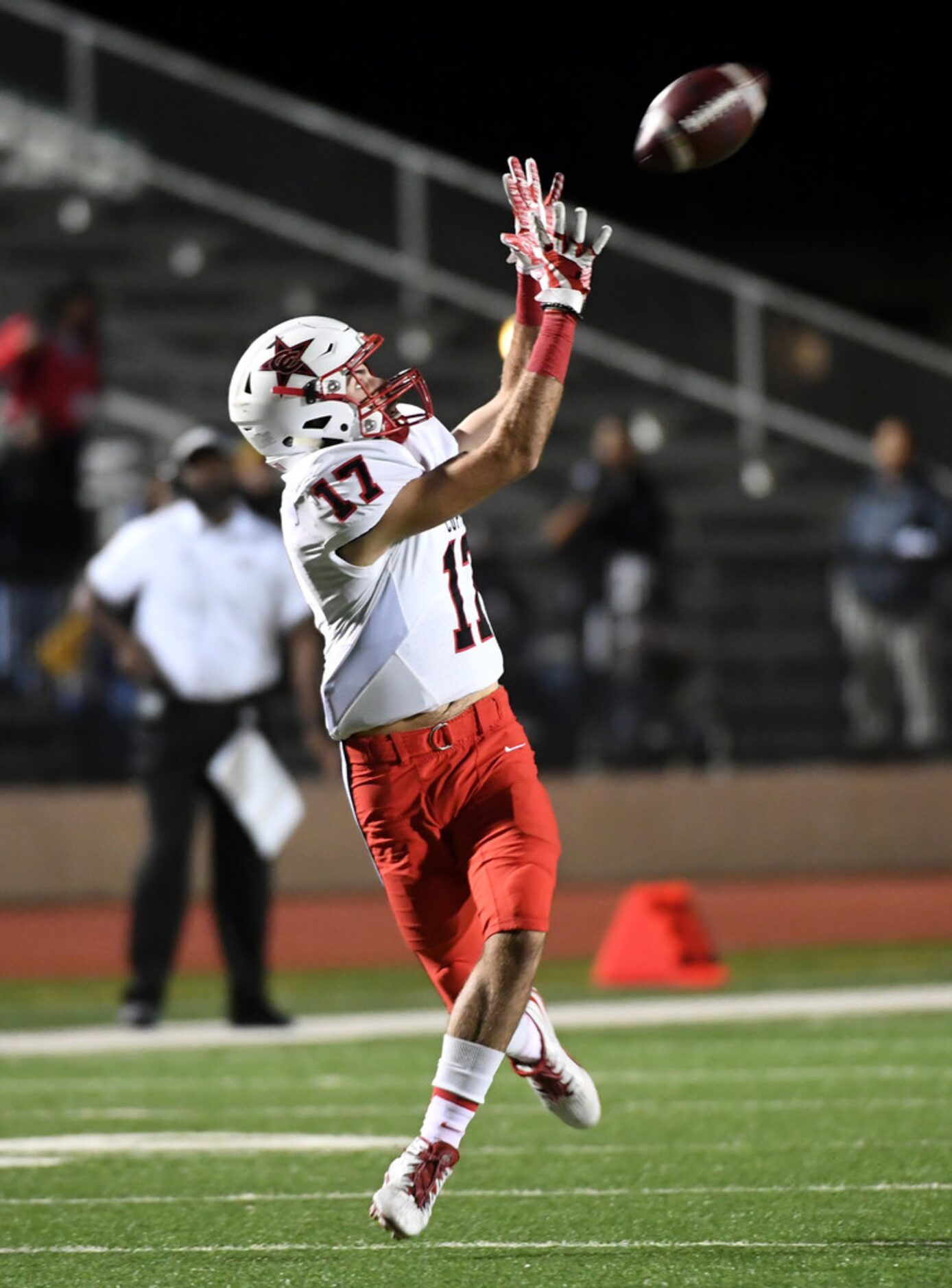 Coppell senior wide receiver Josh Bartolacci (17) hauls in a touchdown pass during the first...