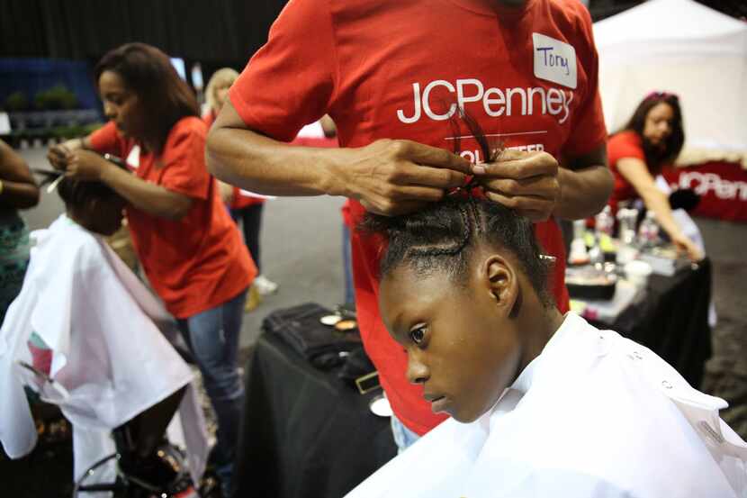 Miracle Orta, a fifth grader at C.F. Carr Elementary School, gets a free salon service from...