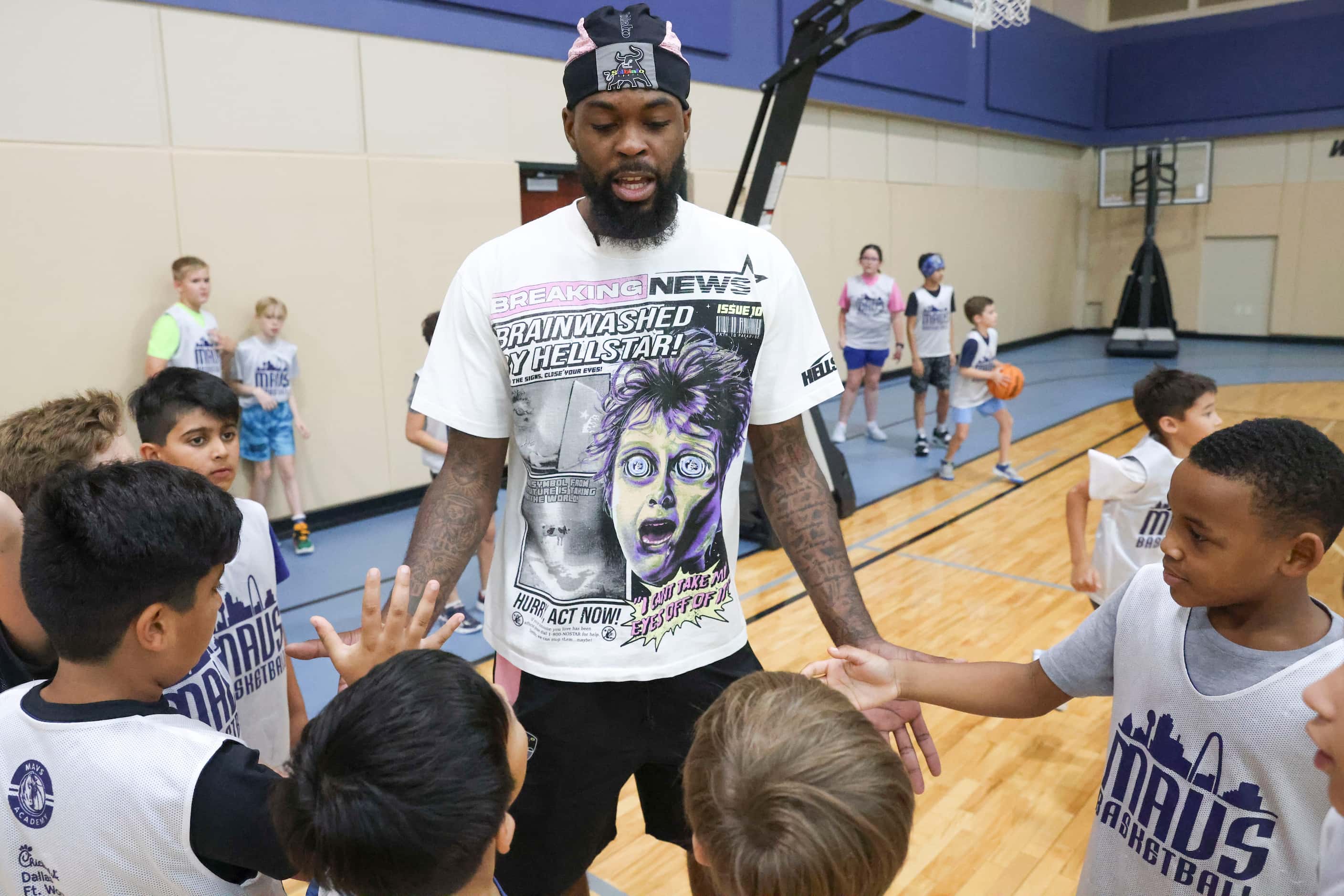 Dallas Mavericks’ Naji Marshall, interacts with young basketball campers during a Hoop Camp,...