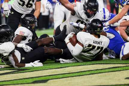 Army Black Knights offensive lineman Jordyn Law (77) recovers Army Black Knights quarterback...