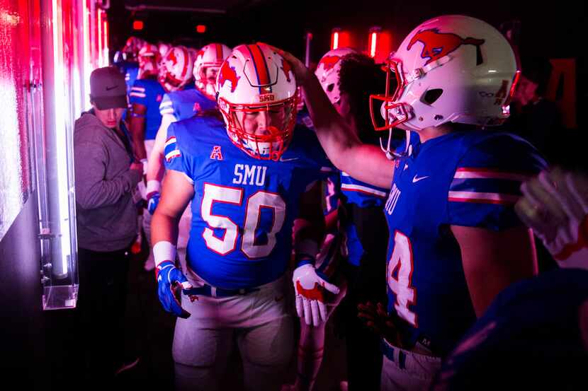 SMU Mustangs defensive end Paka Davis (50) gets a pat on the helmet as he walks out to the...