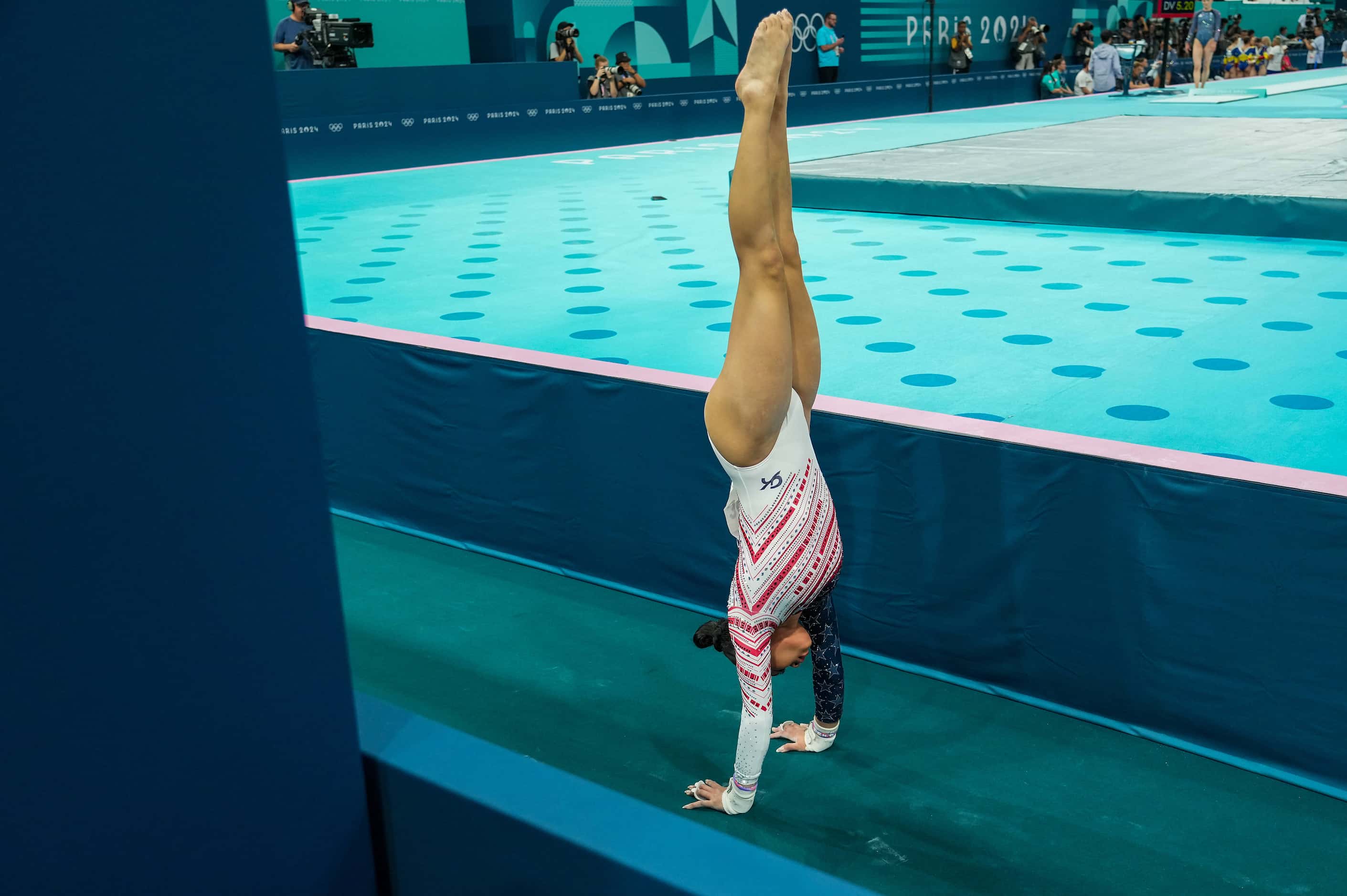 Suni Lee of the United States warms up before she competes on the uneven bars during the...