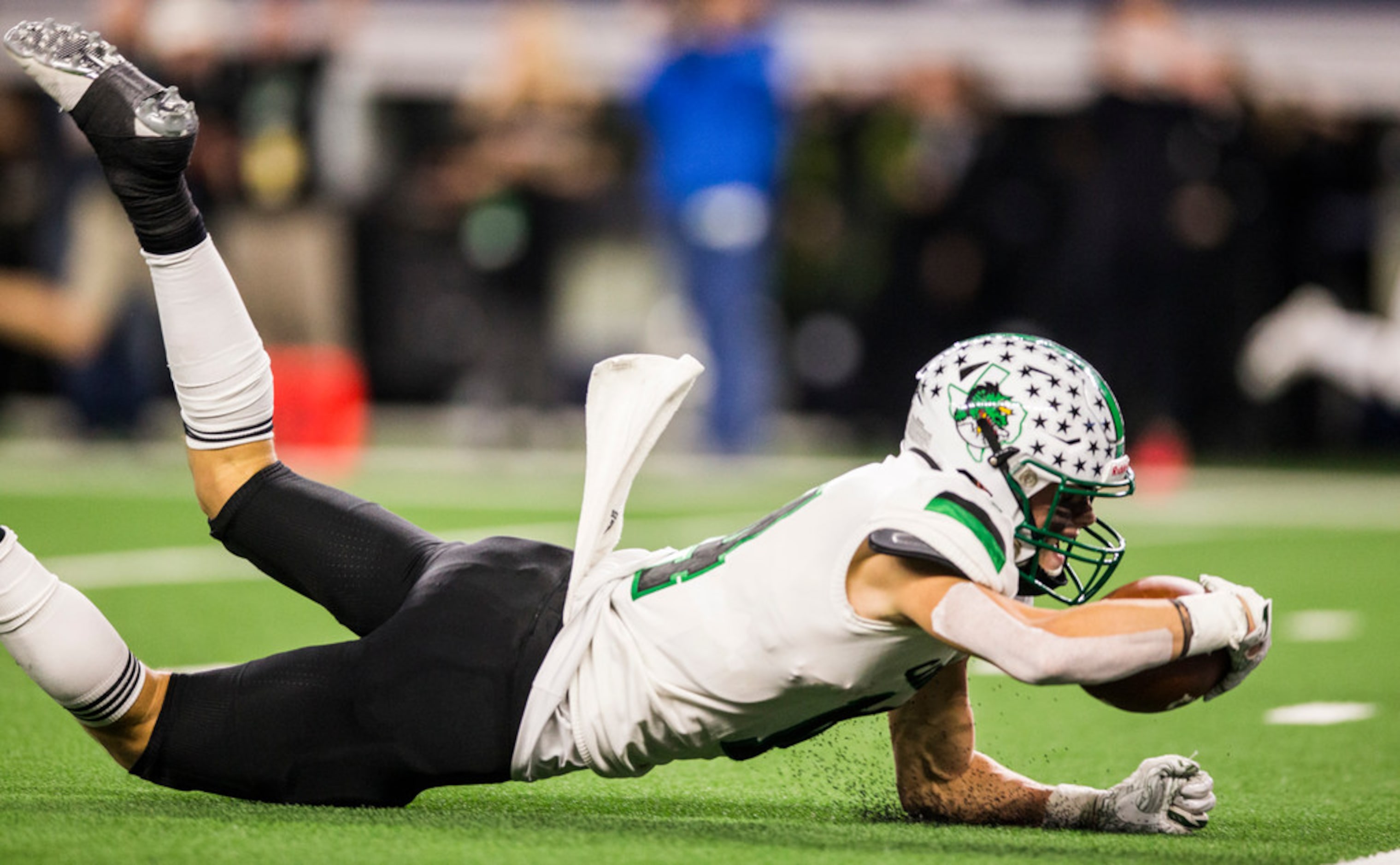 Southlake Carroll running back Owen Allen (4) dives toward the end zone for a touchdown...