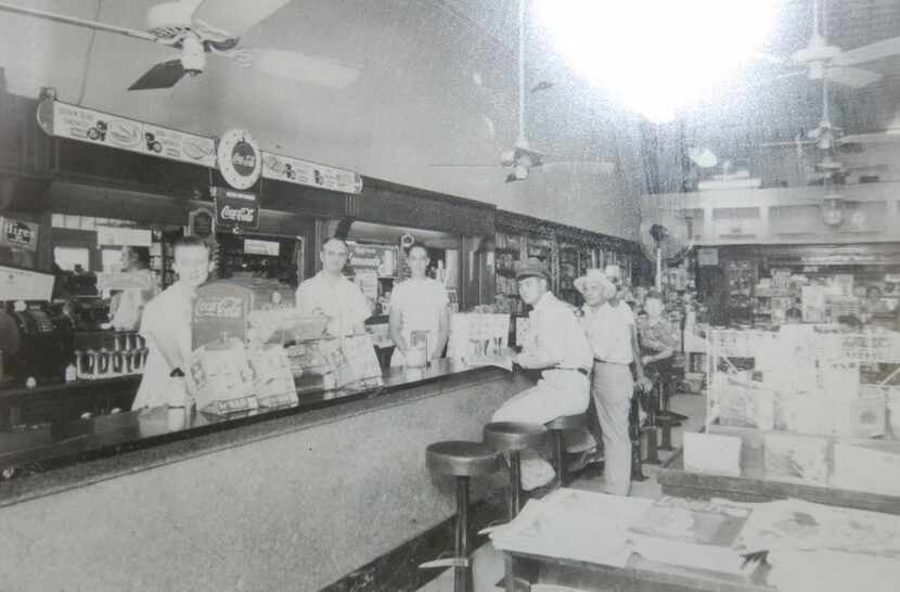 Just before the lunch rush, sometime in the late 1940s, at the Highland Park Pharmacy,...