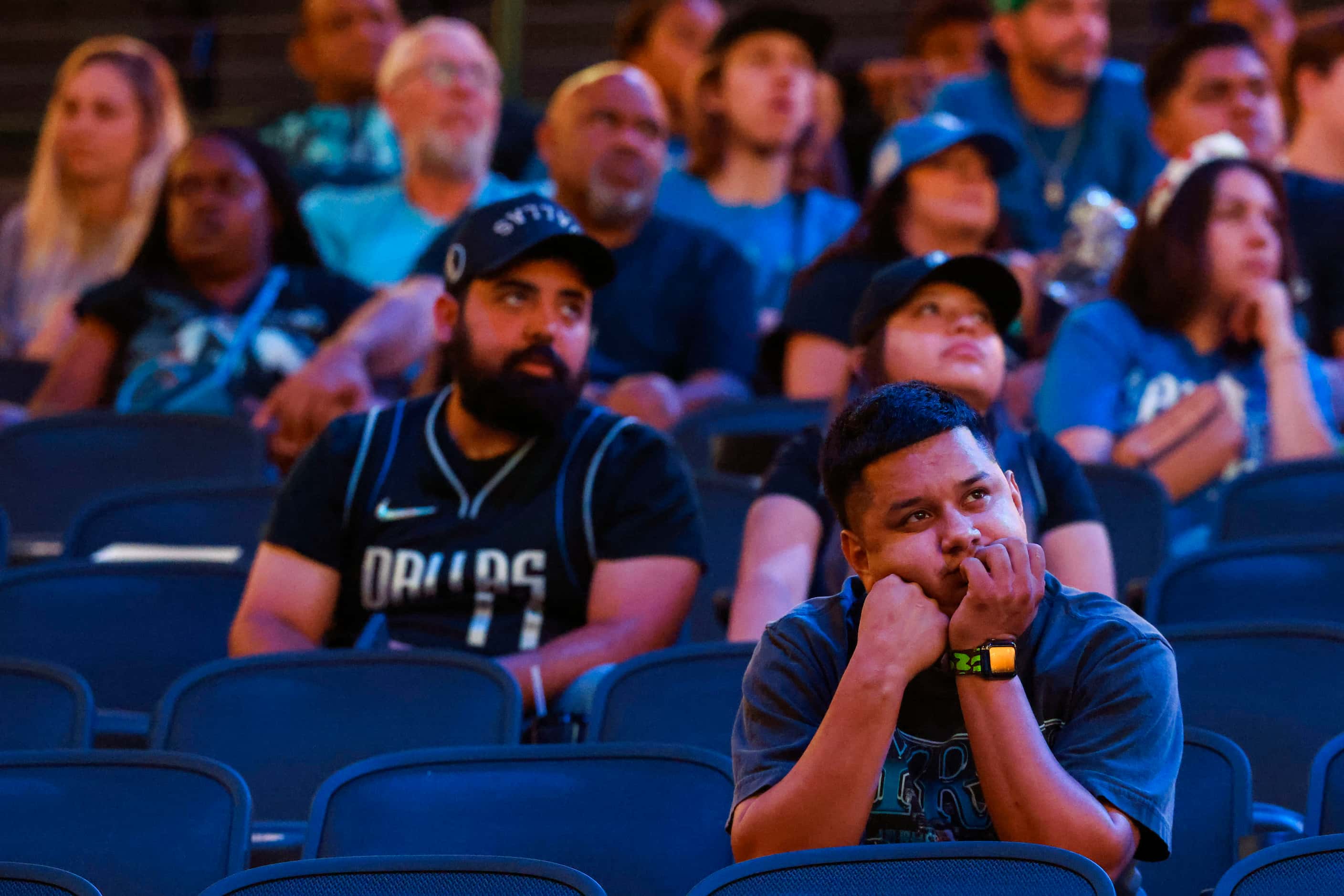 Dallas Mavericks fans look dejected in a watch party followed by the teams’ defeat in the...