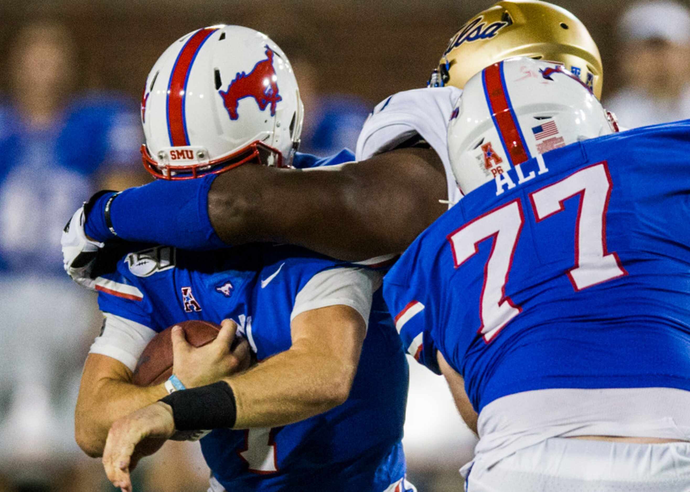 SMU Mustangs quarterback Shane Buechele (7) is sacked by Tulsa Golden Hurricane nose tackle...