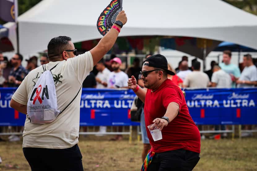 Robert Loredo (left) dances with Cristian Garza as the festivities ramp up at the festival. 