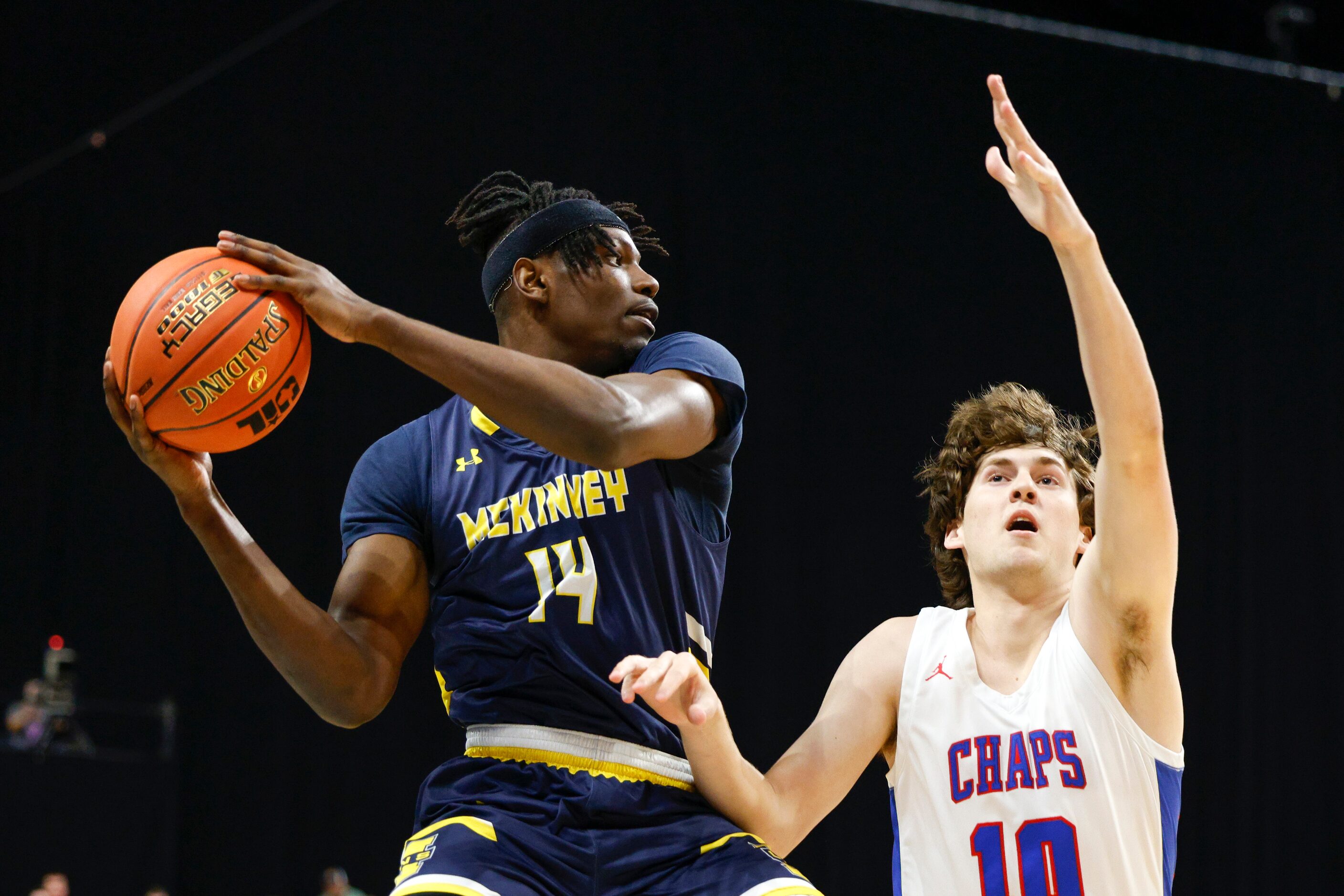 McKinney guard Alex Anamekwe (14) looks to pass around Austin Westlake forward Michael...